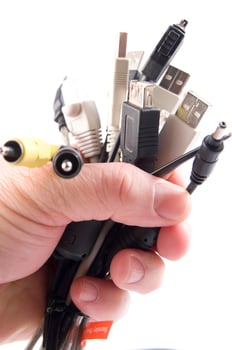a hand holding several different types of cables photo