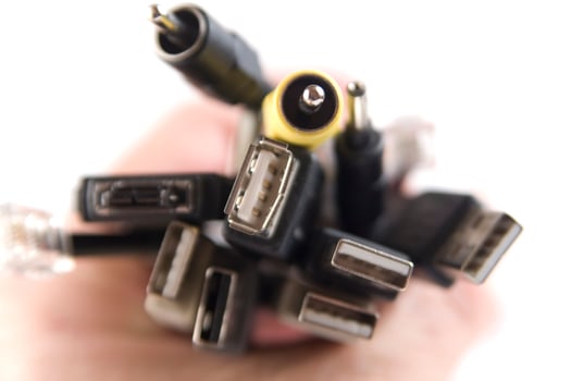 a hand holding several different types of cables photo