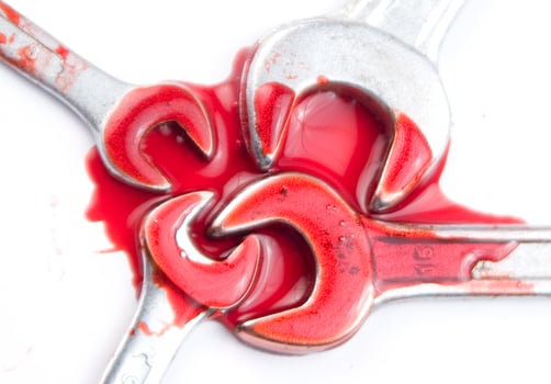 three wrenches with red liquid on them photo