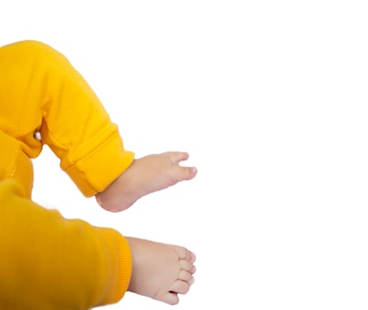 Baby Legs and Bottom in a Diaper and Yellow Panties, Top View, Copy Space photo