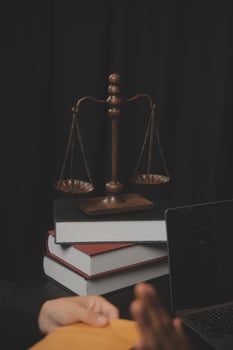 Business and lawyers discussing contract papers with brass scale on desk in office. Law, legal services, advice, justice and law concept picture with film grain effect photo