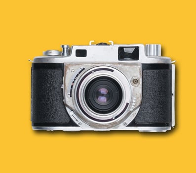 vintage old film camera on yellow background photo