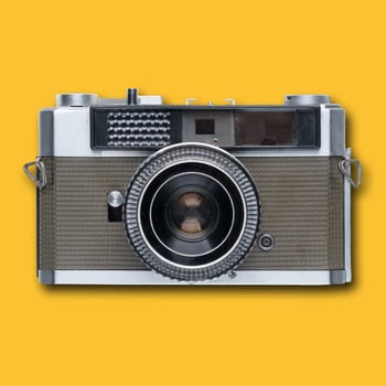 vintage old film camera on yellow background photo