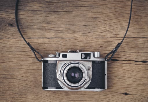 vintage old film camera on wood board photo