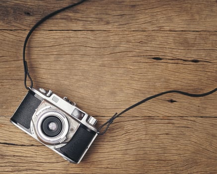 vintage old film camera on wood board photo