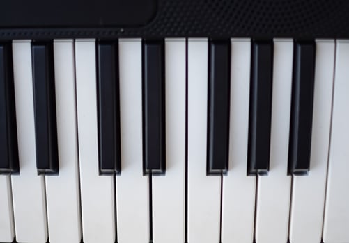 Close-up of piano keys. Piano black and white keys and Piano keyboard musical instrument placed at the home balcony during sunny day. photo