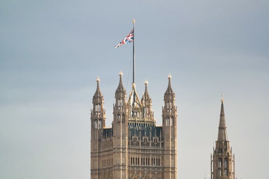 Beautiful Low Angle View of Historical Big Ben Clock Tower from river Thames and London Eye, Westminster Central London, England Great Britain, UK. Image Captured During Cloudy Day of August 2nd, 2023 photo