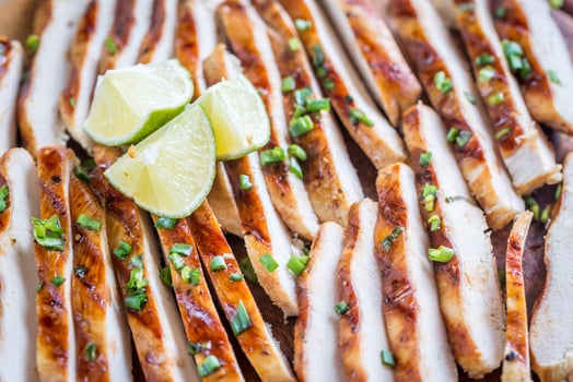 Slices of grilled chicken in lime sauce photo
