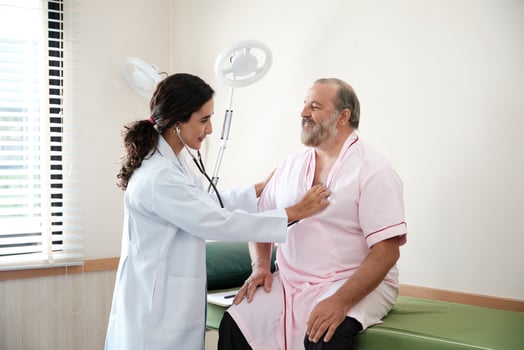 Female doctors in uniform healthy check White male patients in examination coat by stethoscope, and checkups and advise health care diagnosis at clinic hospital, and appointments visit. photo