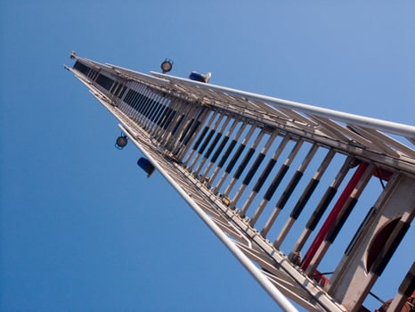 a tall metal tower with a blue sky in the background photo