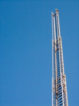 a tall metal tower with a blue sky in the background photo