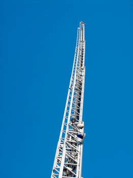 a tall metal tower with a blue sky in the background photo