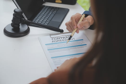 Business and lawyers discussing contract papers with brass scale on desk in office. Law, legal services, advice, justice and law concept picture with film grain effect photo