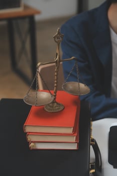 Business and lawyers discussing contract papers with brass scale on desk in office. Law, legal services, advice, justice and law concept picture with film grain effect photo