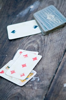 a person is playing cards with a deck of cards photo