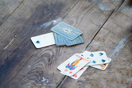a person is playing cards with a deck of cards photo