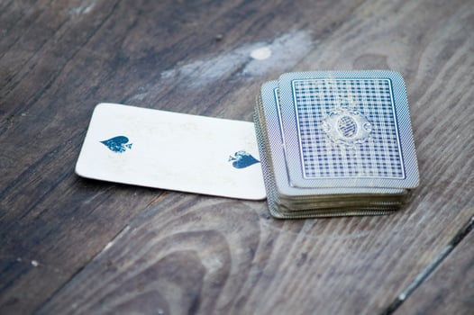 a person is playing cards with a deck of cards photo
