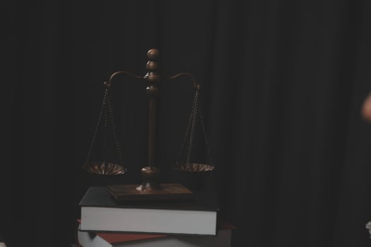 Business and lawyers discussing contract papers with brass scale on desk in office. Law, legal services, advice, justice and law concept picture with film grain effect photo