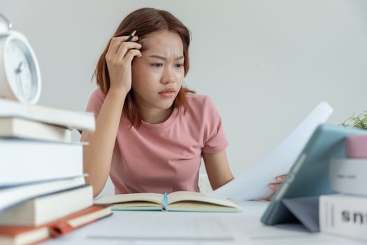 Asian student woman have anxiety because of exams, female prepare for test and learning lessons in the library. stress, despair, haste, misunderstanding reading, discouraged, expectation, knowledge photo