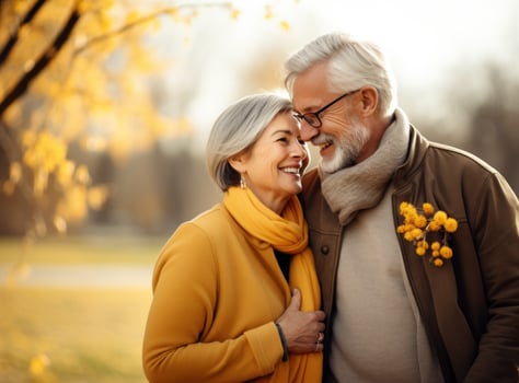 Happy senior couple in autumn park photo