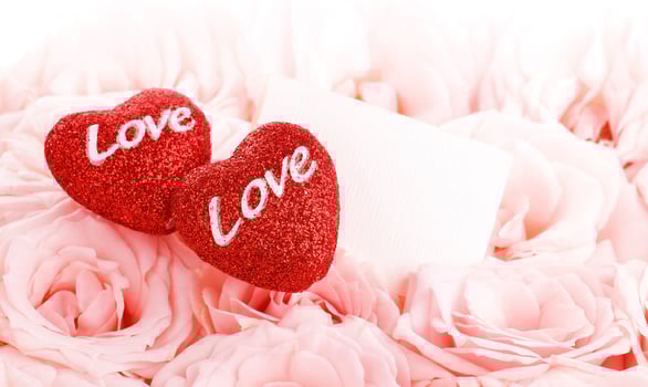 Beautiful pink roses with gift card and hearts photo