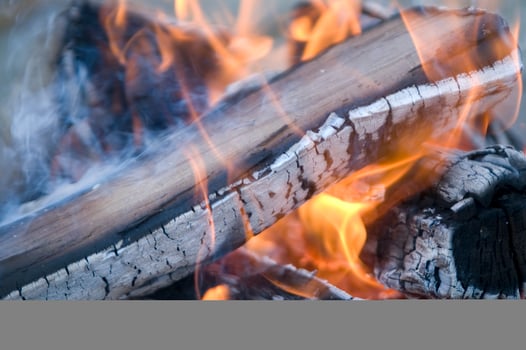a close up of a fire with wood and coal photo