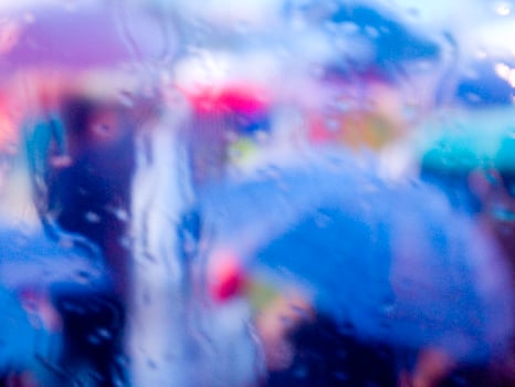 a blurry image of a person holding an umbrella photo