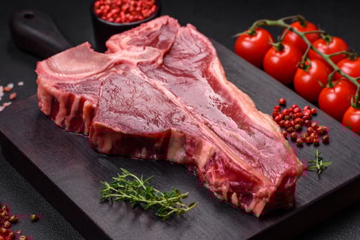 Raw fresh juicy beef t-bone steak with salt, spices and herbs photo