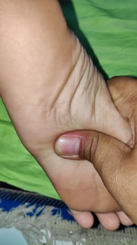Young woman having foot massage in beauty salon, close up view photo