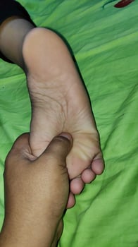 Young woman having foot massage in beauty salon, close up view photo