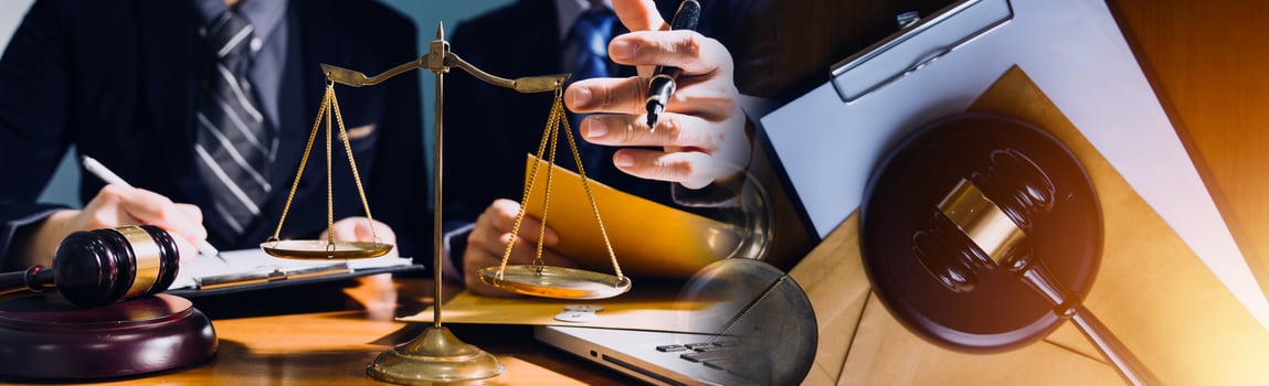 Business and lawyers discussing contract papers with brass scale on desk in office. Law, legal services, advice, justice and law concept picture with film grain effect photo