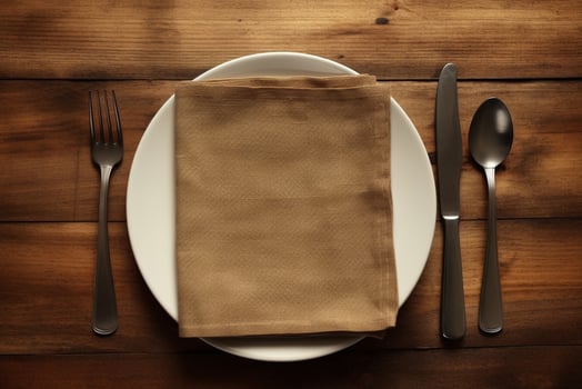 a napkin on white plate with knife folk and spoon on wooden background generative AI photo