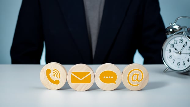 Website page, contact us or email marketing concept, customer support hotline, contact us. Businessman sitting and working on computer. Email, phone, address, chat message icon. photo