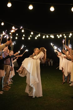 newlyweds at a wedding of sparklers photo