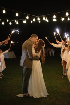 newlyweds at a wedding of sparklers photo