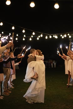 newlyweds at a wedding of sparklers photo