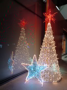 Christmas decoration outdoors. White tree with colorful stars photo
