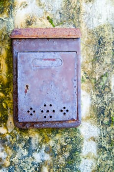 an old, rusty, metal box with holes on it photo