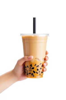 A hand holding takeaway plastic cup of delicious iced bubble milk tea and black pearls isolated on white background. ai generated photo