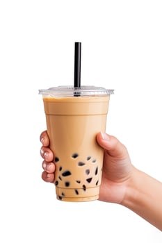 A hand holding takeaway plastic cup of delicious iced bubble milk tea and black pearls isolated on white background. ai generated photo