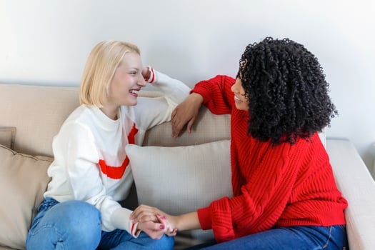 Candid diverse girls best friends embracing standing indoors, close up satisfied women face enjoy tender moment missed glad to see each other after long separation, friendship warm relations concept photo