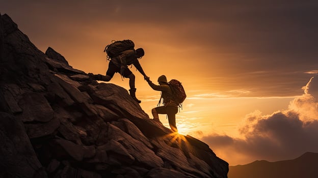 Assisting climbers on rocky mountain at sunset during a perilous situation photo