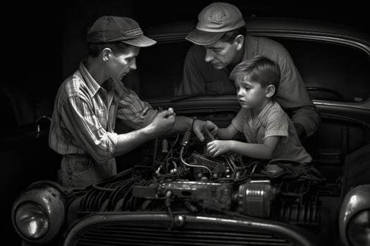 A father and son working on a car together photo