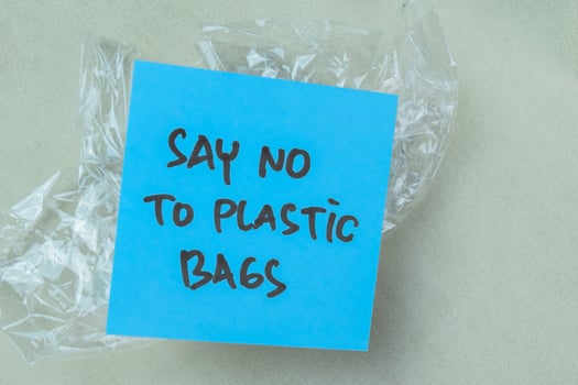 Concept of Say No To Plastic write on book isolated on Wooden Table. photo