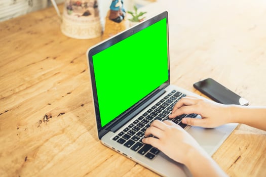 Close-up of business female working with laptop and smartphone in coffee shop like the background photo
