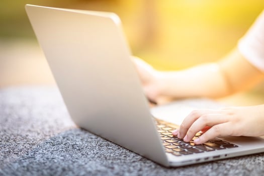 Close-up of business female working with laptop and smartphone in at the park on office outdoor. photo