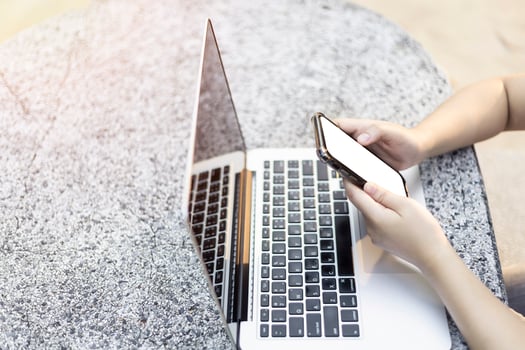 Close-up of business female working with laptop and smartphone in at the park on office outdoor. photo