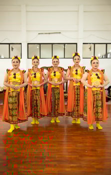 a group of traditional Sundanese dancers standing with their friends before the performance starts photo