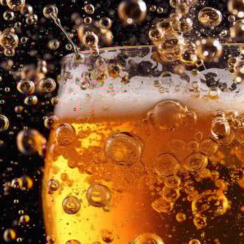 Cold Craft light Beer in a glass with water drops. Pint of Beer close up isolated on black color background. photo