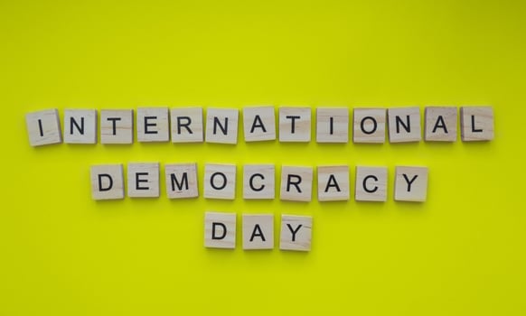 September 15, International Day of Democracy, minimalistic banner with the inscription in wooden letters photo